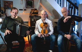 the 3 members of Miscellany of Folk with instruments.